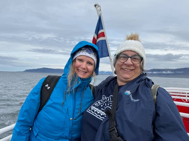 Two Lakers smile on a boat while visiting Iceland